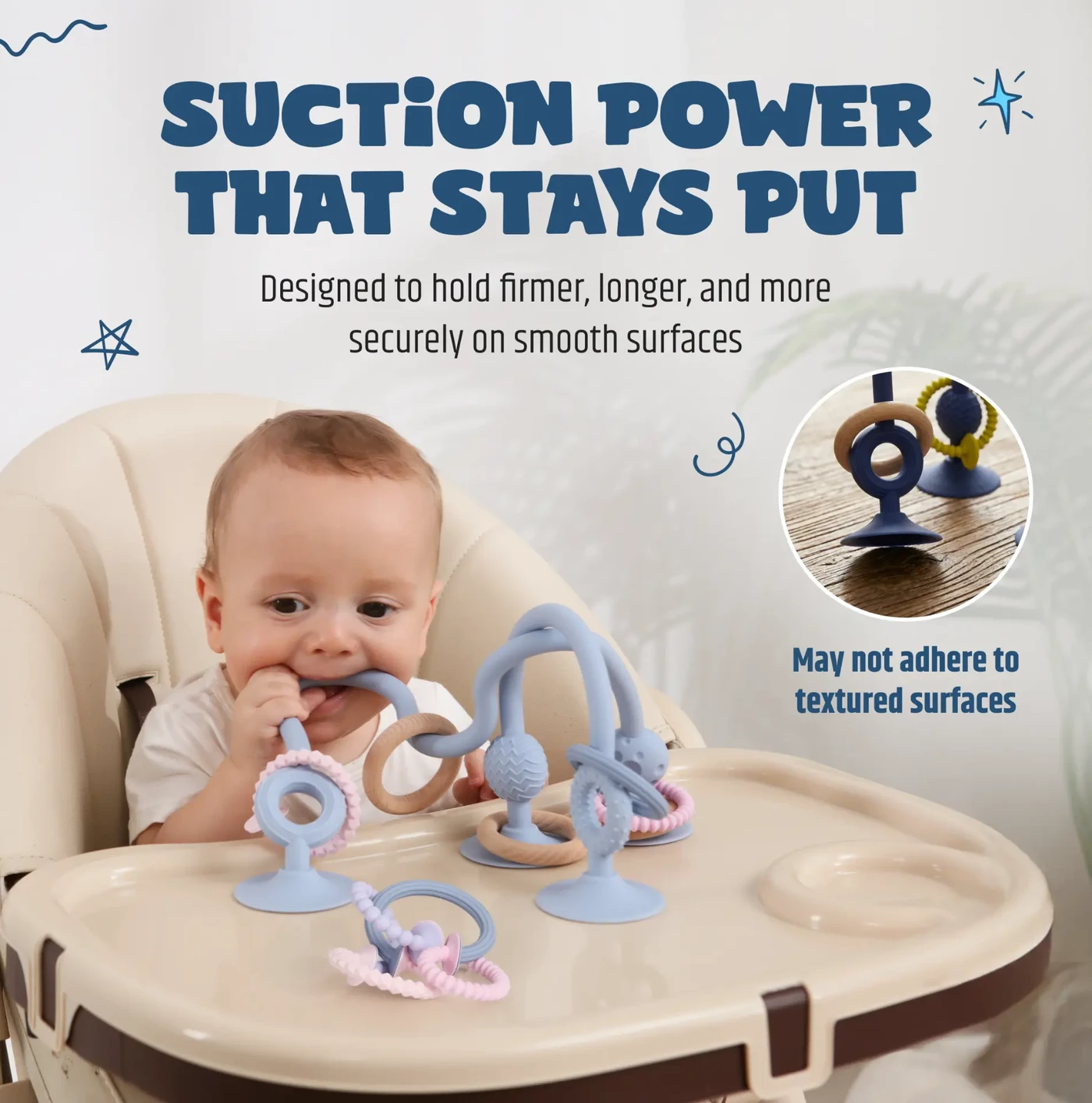 Jumble Jangle suction toy stuck to a high chair tray with a baby chewing one of the silicone arms