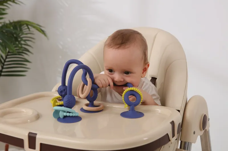 Jumble Jangle suction teether with textured silicone rings and natural wooden rings