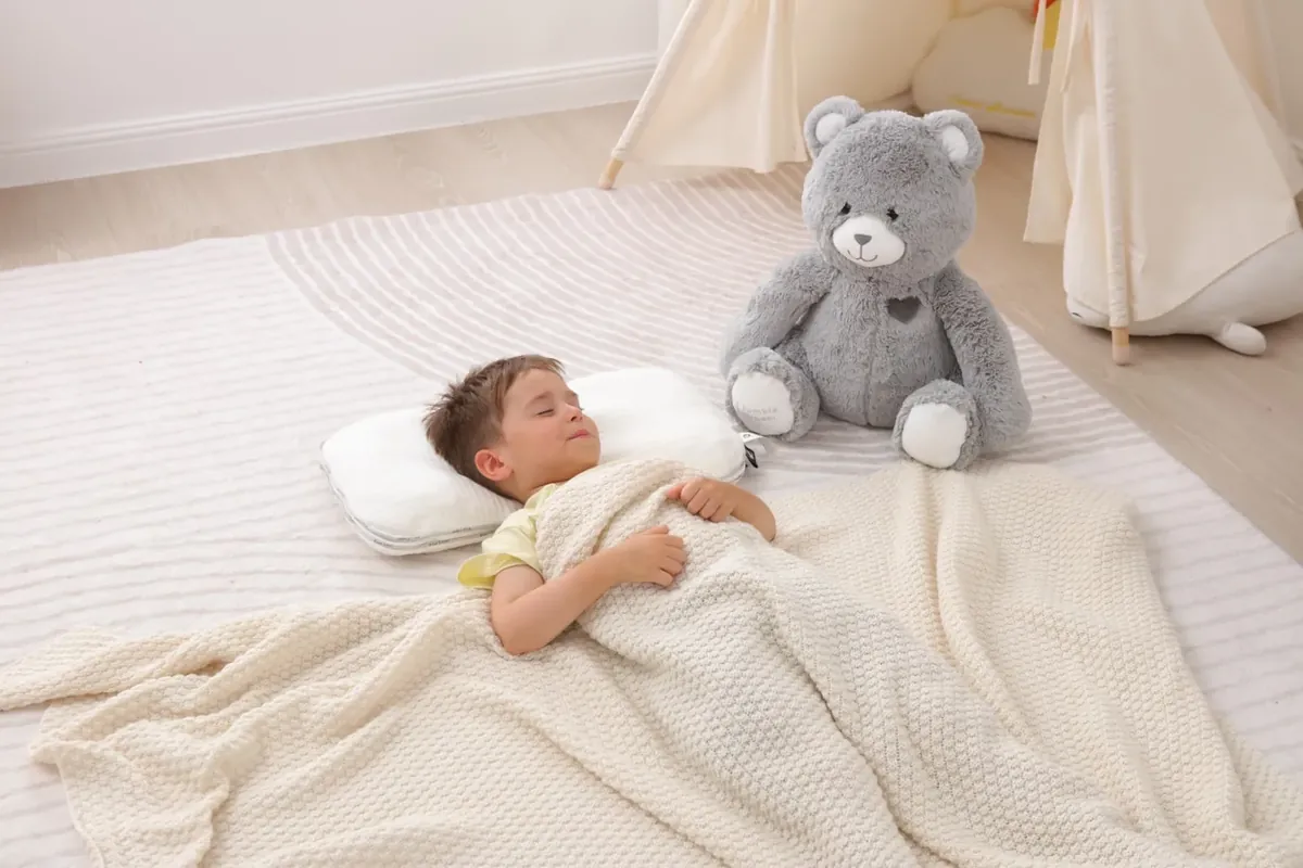 Child hugging the grey Jumble Bear weighted stuffed animal