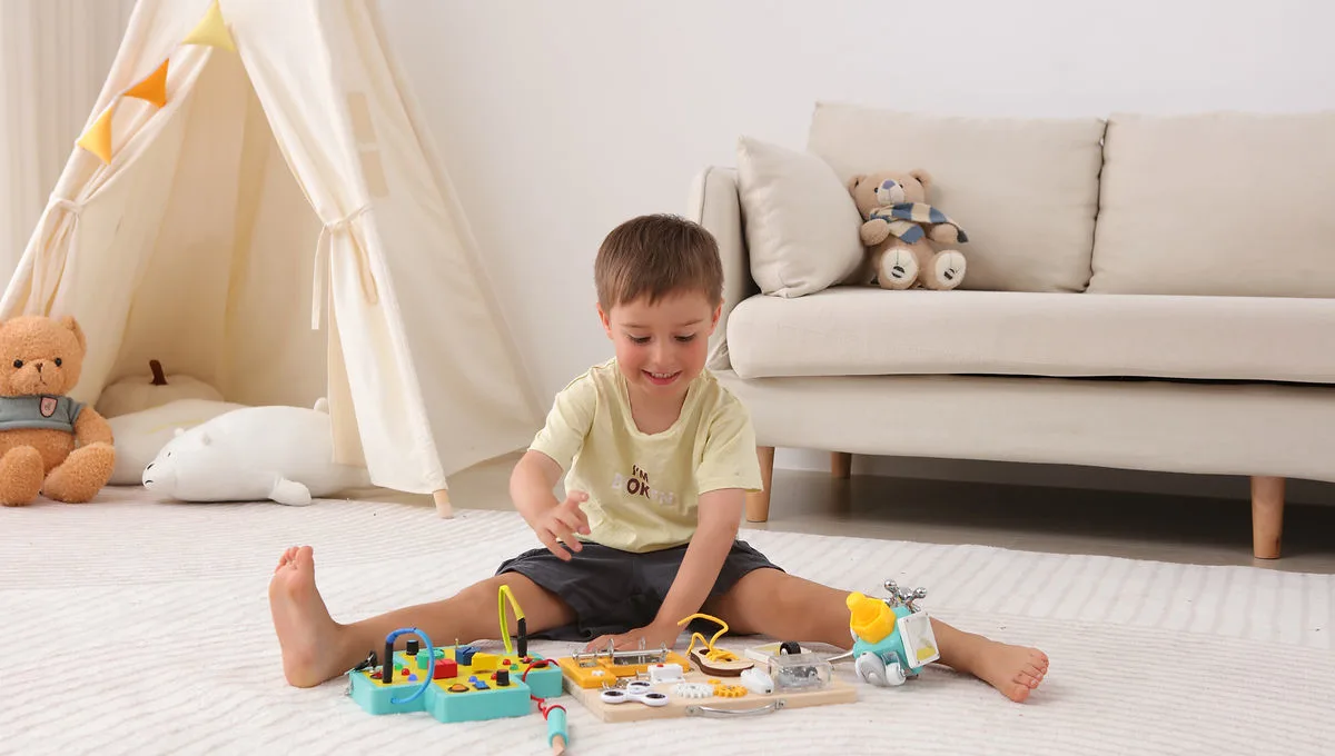 Toddler sitting on a rug exploring a wooden Jumble Dream Montessori toy