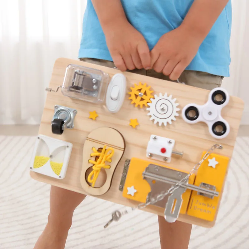 Toddler turning latches on the Jumble Busy Board wooden activity board