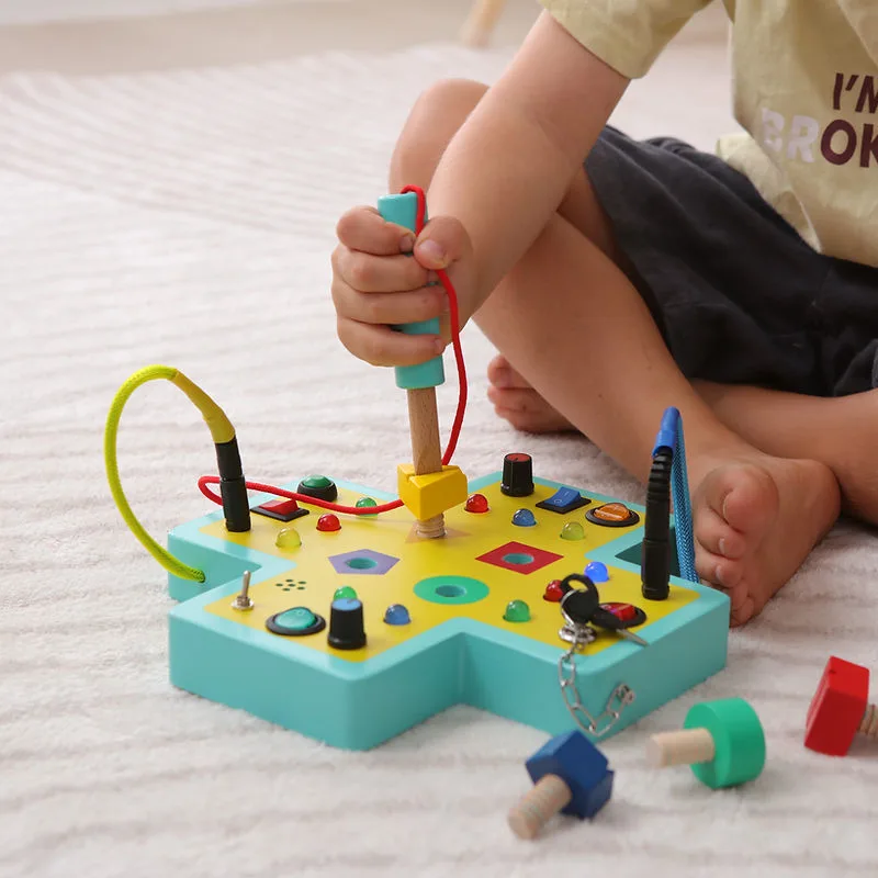 Jumble Switch Board wooden panel with light switches and sliders for little hands